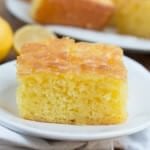 Slice of Lemon Jello Cake on a white plate.