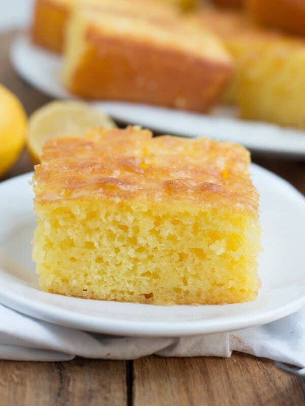 Slice of Lemon Jello Cake on a white plate.