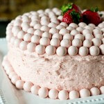 Turn a boxed cake mix into a special Strawberry Malted Milkshake Cake. Homemade strawberry buttercream frosts the inside and out of this vanilla malted milk cake. Decorate quickly and easily with Strawberry Whoppers!