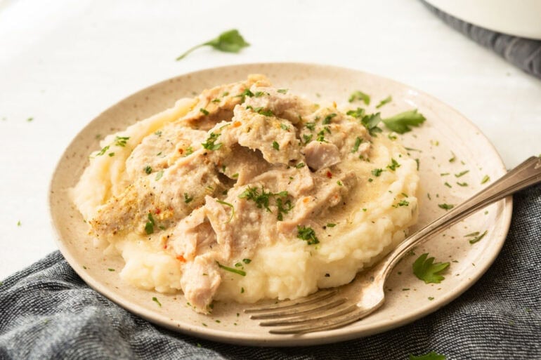 Tender shredded pork chops and mashed potatoes topped with homemade gravy