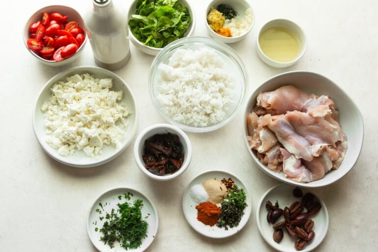 Several bowls full of different ingredients for a mediterranean meal.