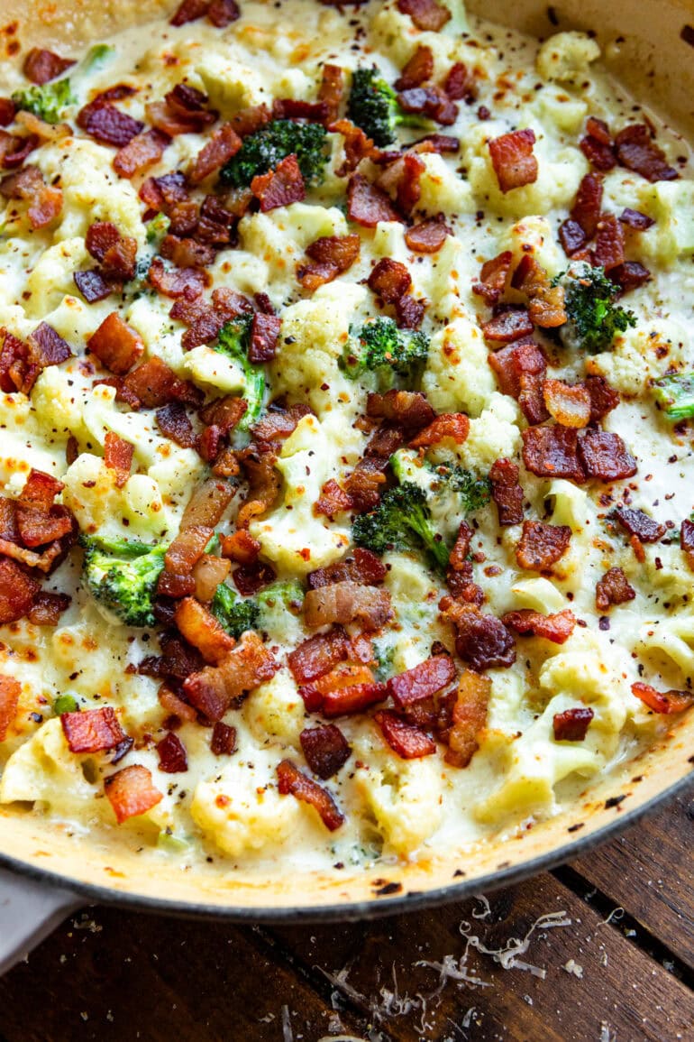 a photo of creamy broccoli and cauliflower topped with crispy bacon bits