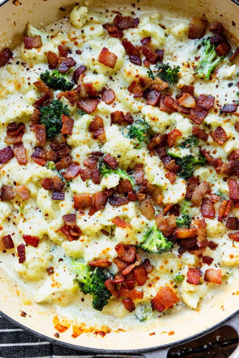 a photo of a skillet full of creamy garlic parmesan cauliflower and broccoli