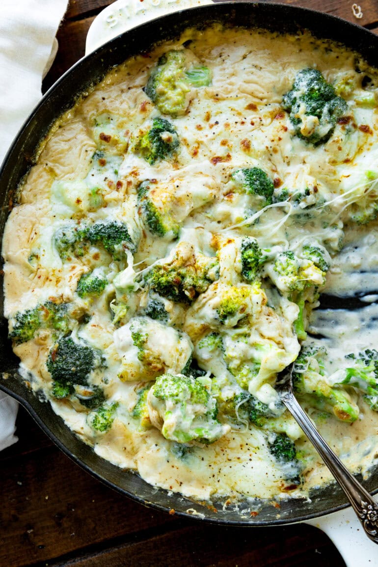 Photo of stirring creamy cheesy broccoli in large skillet