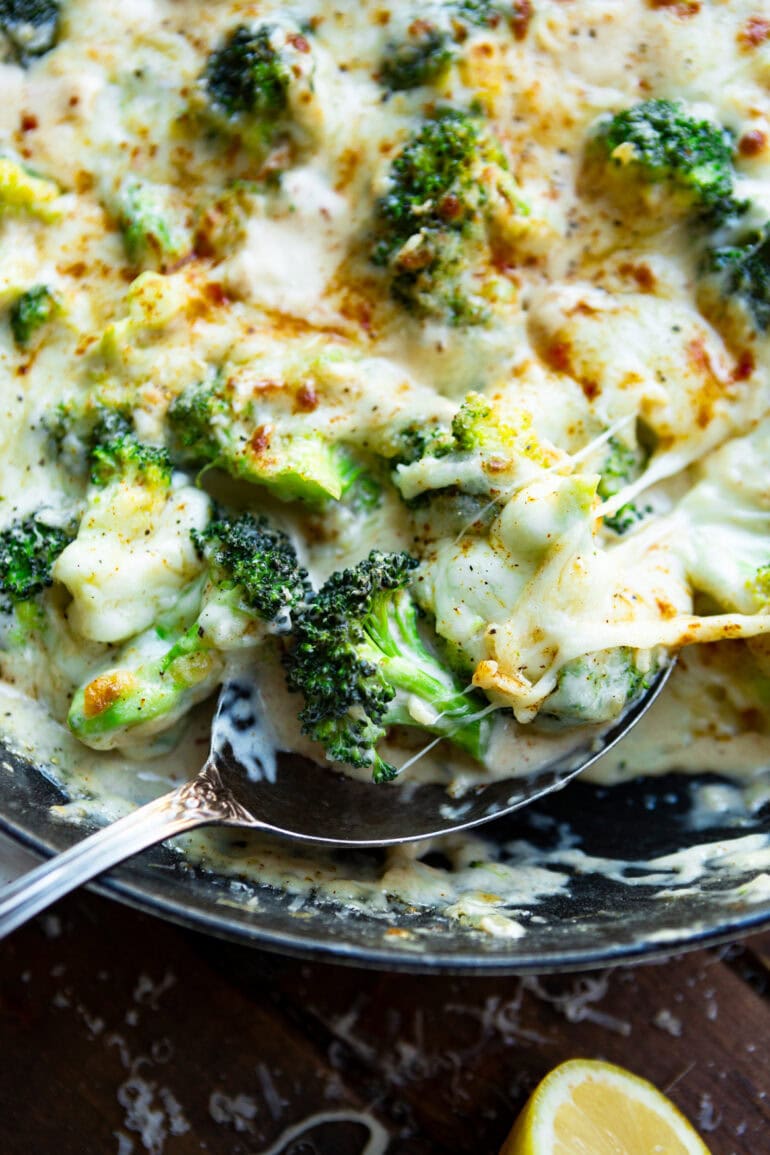 A picture of a frying pan filled with creamy garlic Parmesan broccoli, sc