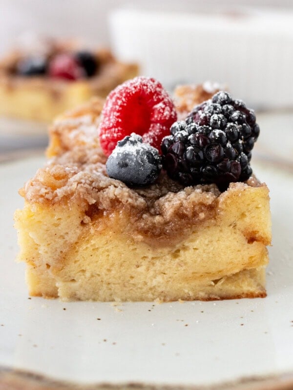 a photo of a piece of french toast casserole topped with fresh berries