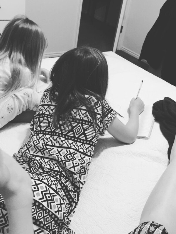 A picture of our two girls writing in their journals.