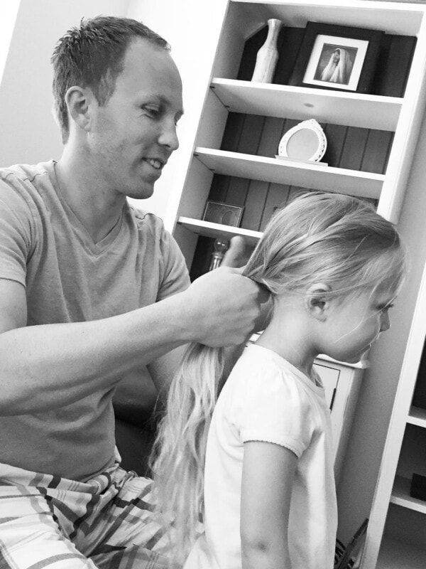 A photo of Cade braiding one of our daughter's hair.