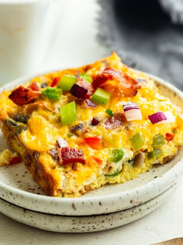 a serving of bacon and egg casserole with onions and peppers