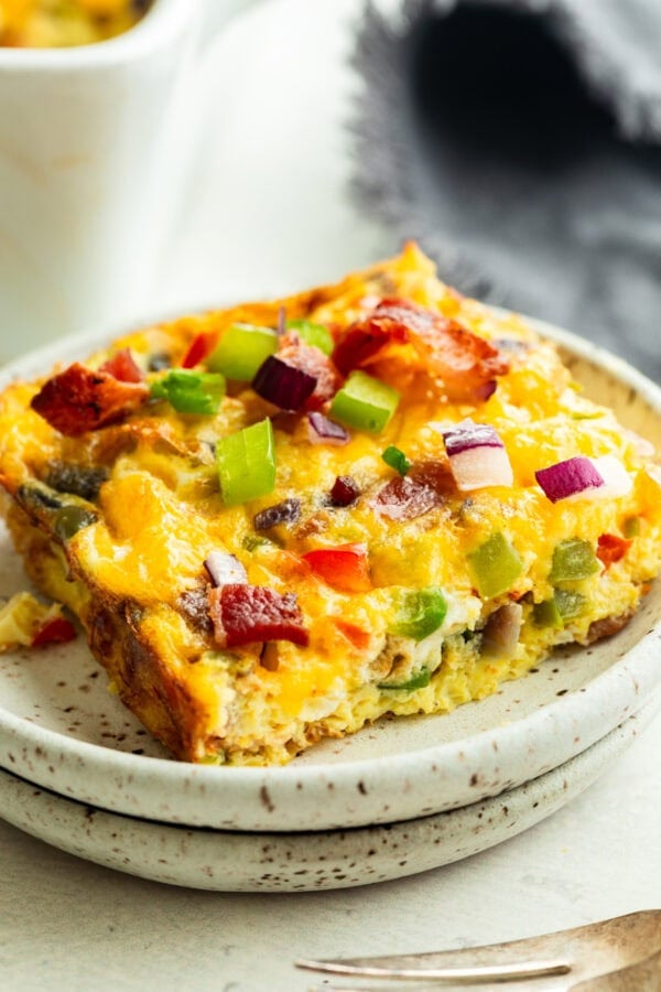a serving of bacon and egg casserole with onions and peppers