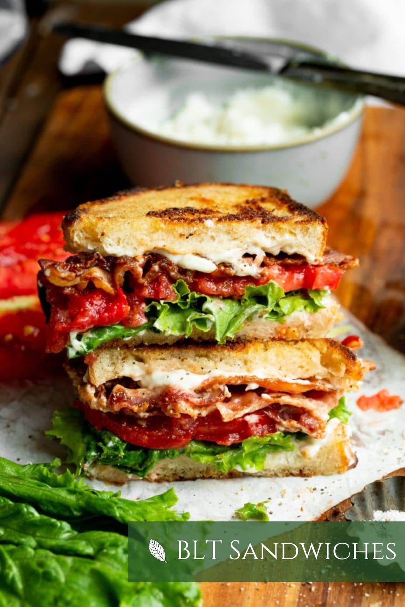 a photo of a BLT cut in half and stacked on top of each other so you can see the inside of the layers