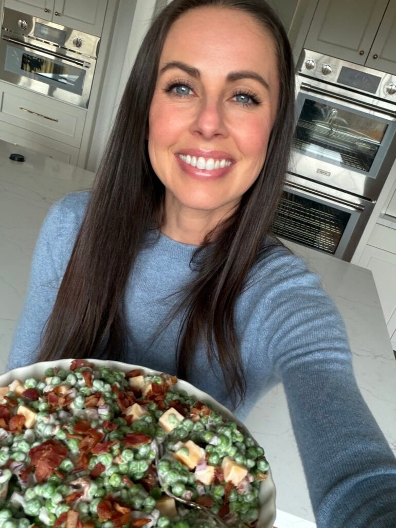 carrian holding a large serving bowl of English pea salad