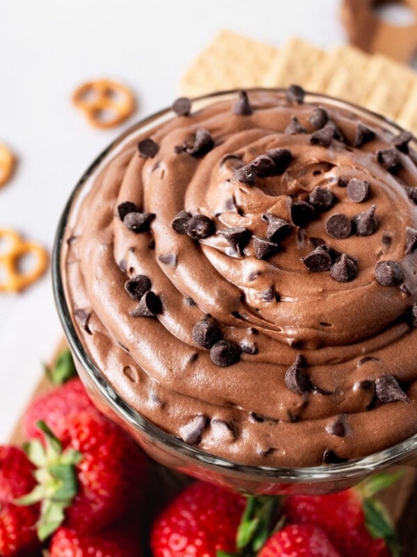 a photo of a glass bowl full of brownie batter dip topped with minute chocolate chips