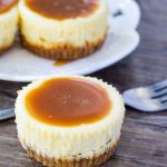 These mini cheesecakes with salted caramel sauce have a crunchy graham cracker crust, creamy cheesecake layer and are are topped with salted caramel sauce.