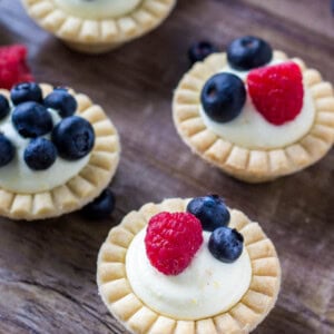 Mini fruit tarts with fresh berries and sweet vanilla filling.