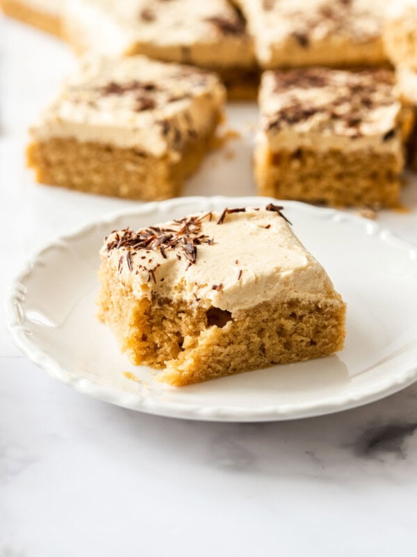 a slice of peanut butter sheet cake on a white saucer