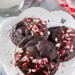 Peppermint Double Chocolate Cookies have a rich chocolate taste and are infused with peppermint. They're dipped in chocolate and sprinkled with crushed candy canes for the perfect holiday cookie!