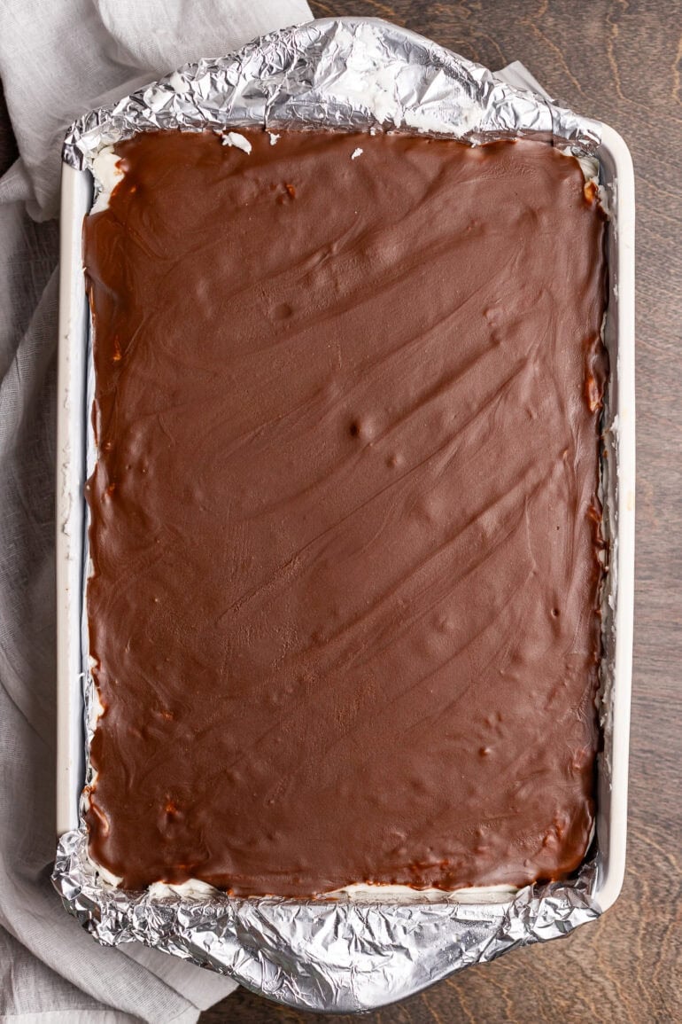 a 9x13 pan full of baked peppermint brownies topped with glossy chocolate