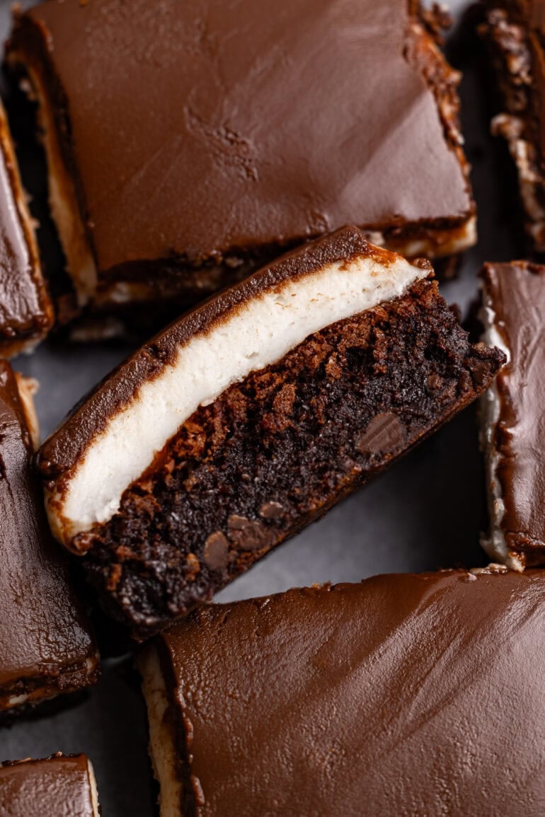 several peppermint brownies with one brownie turned on its side so you can see the cross section