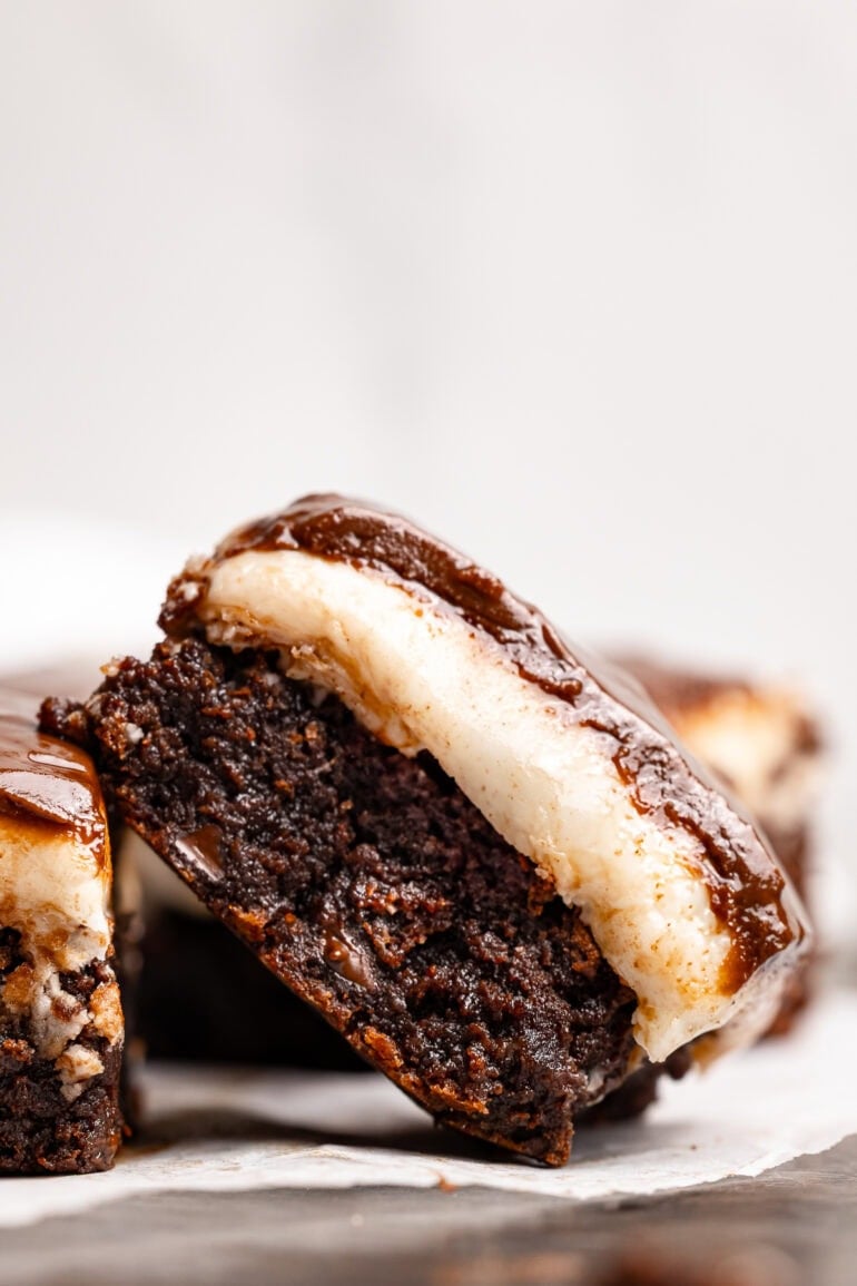 a single peppermint patty brownie tilted on it's side showing the creamy peppermint layer and thin, glossy chocolate layer on top