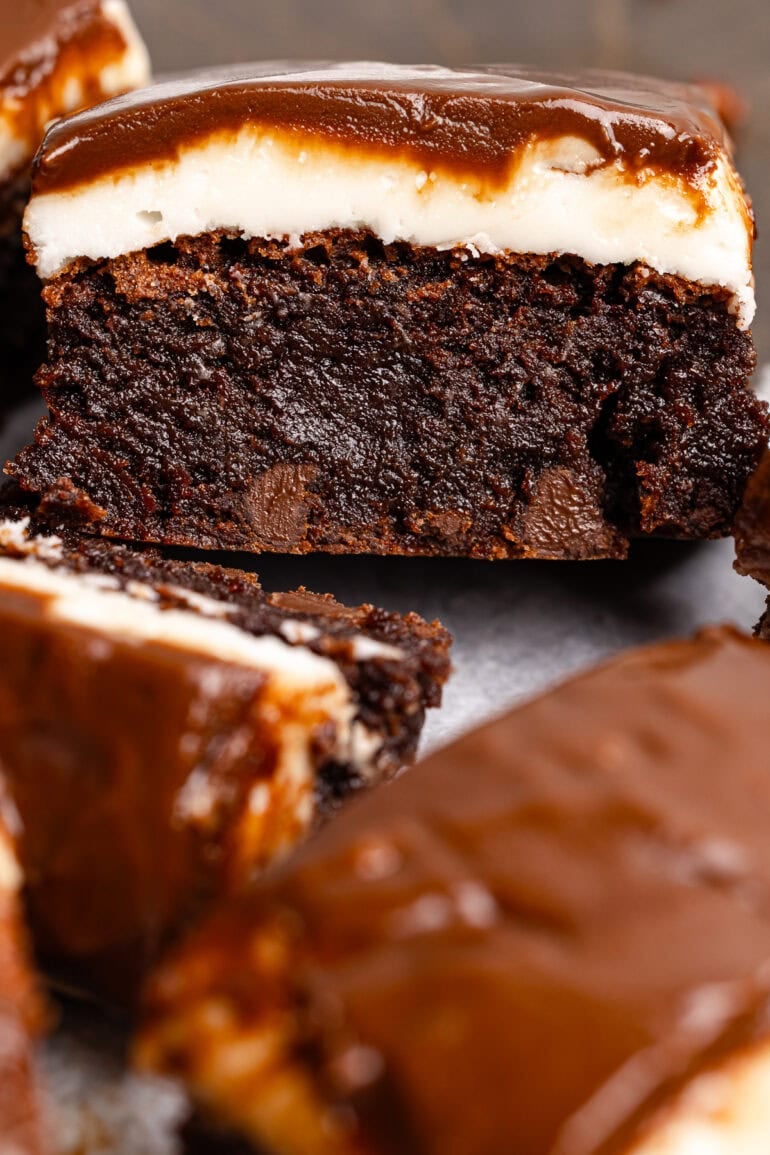 a thick and fudgy chocolate brownie with a peppermint patty layer then topped with a thin chocolate layer