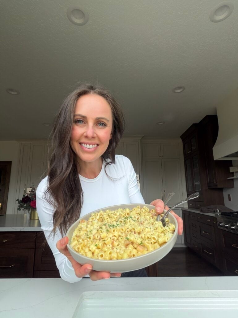 Carrian holding a large bowl of garlic butter pasta