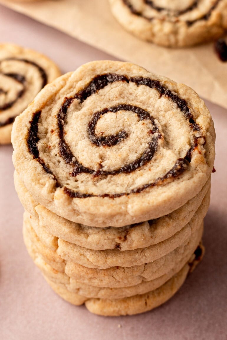 a stack of baked raisin pinwheel cookies