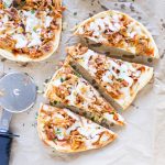 Four slice of easy Pulled Pork Pizza next to a whole flatbread pulled pork pizza.