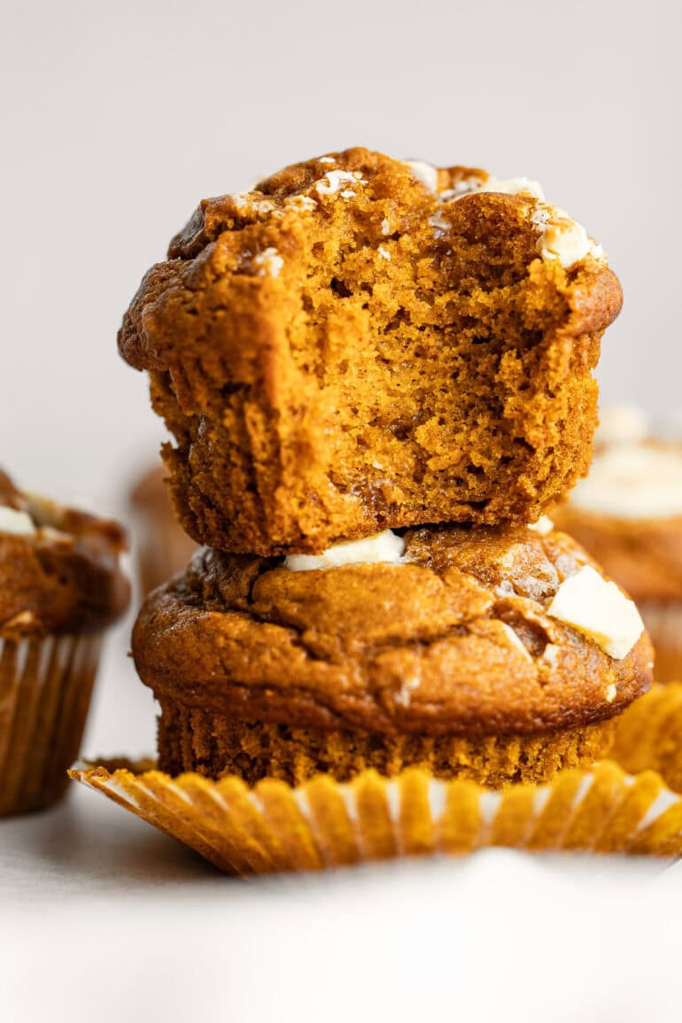 Close-up of a pumpkin white chocolate chip muffin. open to show the moist, fluffy texture.