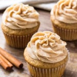 3 spice cake cupcakes topped with cinnamon cream cheese buttercream.
