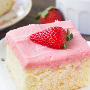Soft, moist vanilla sheet cake topped with strawberry buttercream - you'll love the flavor combo and pretty pink color of this vanilla cake with fresh strawberry frosting.