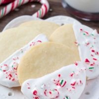 Buttery, melt in your mouth shortbread cookies infused with peppermint then dipped in chocolate and sprinkled with crushed candy canes. These white chocolate peppermint shortbread cookies are perfect for Christmas!