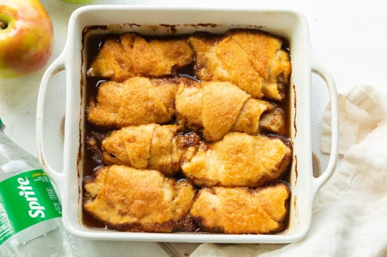 Easy apple dumplings baked until golden brown in a baking dish with buttery brown sugar sauce.