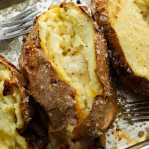 a baked white sweet potato sliced open and fluffed inside