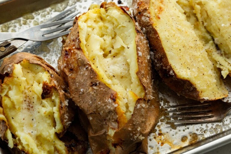 a baked white sweet potato sliced open and fluffed inside