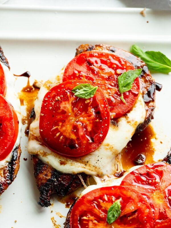 several grilled chicken breasts topped with melted fresh mozzarella, sliced tomatoes, fresh basil and a balsamic glaze - chicken caprese