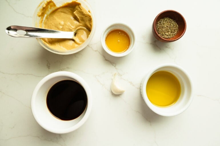 ingredients for balsamic chicken marinade including dijon mustard, oil, balsamic vinegar, pepper, salt, garlic, and other spices