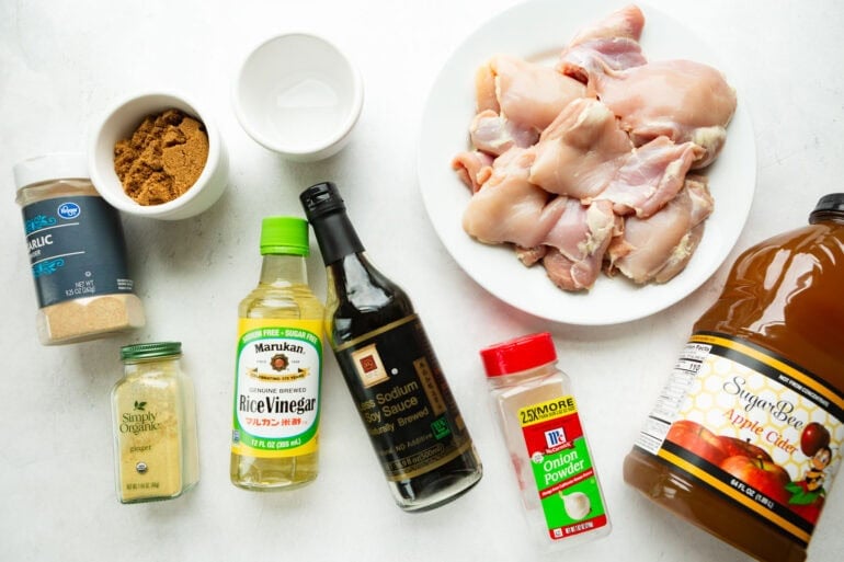 all the ingredients for bourbon chicken including chicken thighs, soy sauce, rice vinegar and various spices