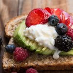 Breakfast berry avocado toast with a drizzle of honey ohsweetbasil.com