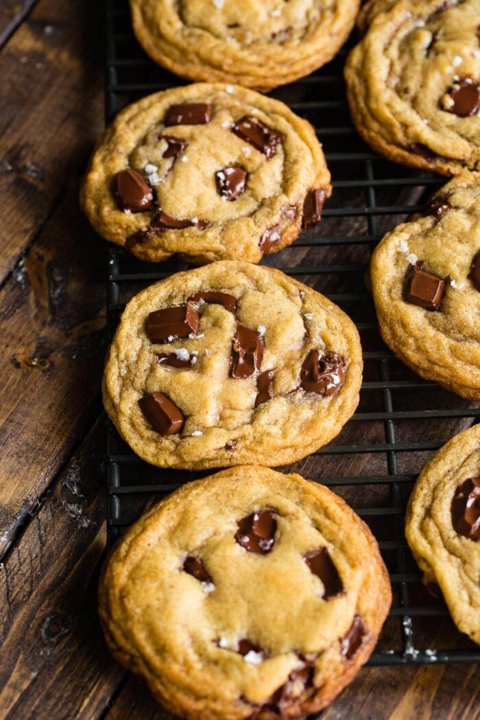 several golden baked brown butter chocolate chunk cookies topped with flaked sea salt