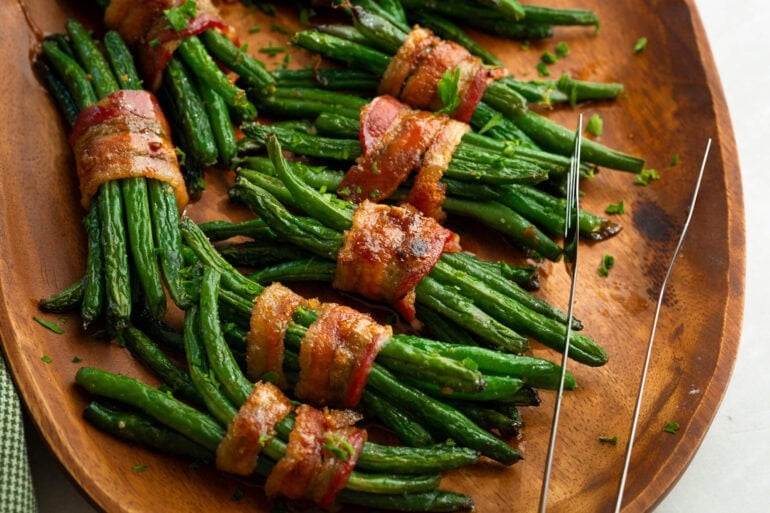 several green bean bundles wrapped in crispy brown sugar bacon
