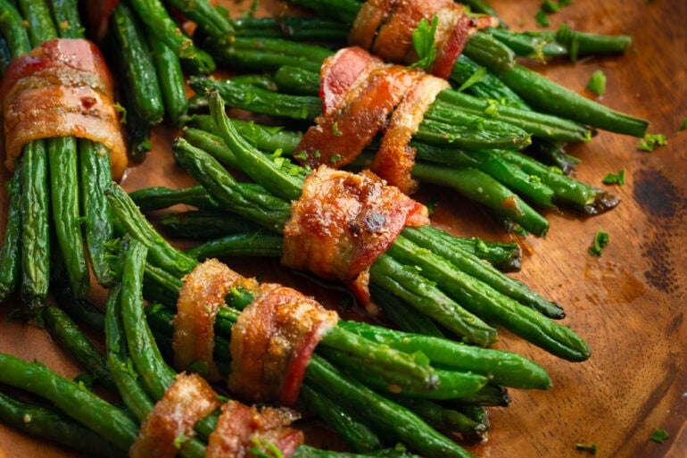several bacon wrapped bundles of buttery seasoned fresh green beans