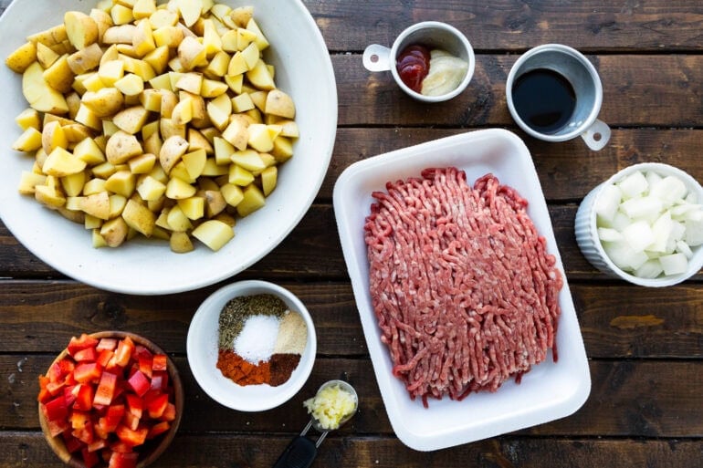a photo of all the ingredients for ground beef and potatoes in separate little bowls and plates
