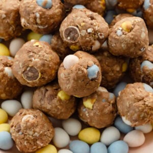 a bowl of cadbury mini egg protein balls sitting on top of cadbury mini eggs