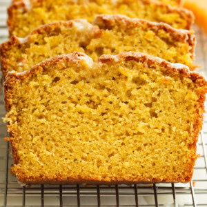 several slices of moist cantaloupe bread topped with a white glaze