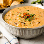 This is the most amazing cheesy ground beef enchilada soup, full of potatoes, beans, corn and ohhhh that cheesy goodness! ohsweetbasil.com
