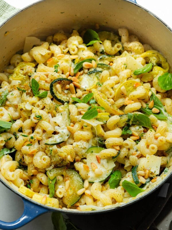 a large pot of tender creamy pasta, sliced zucchini and yellow squash and fresh herbs