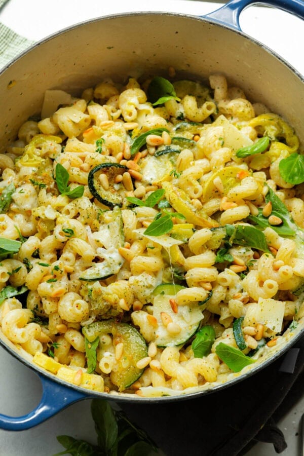 a large pot of tender creamy pasta, sliced zucchini and yellow squash and fresh herbs