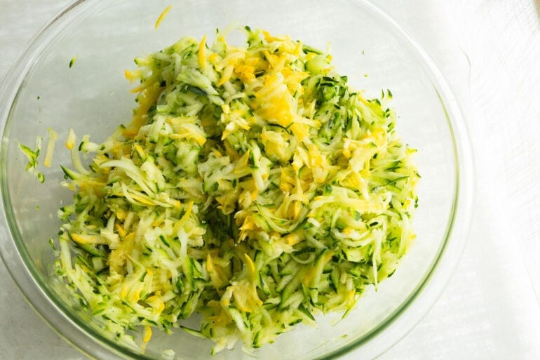 Fresh zucchini being shredded for zucchini casserole