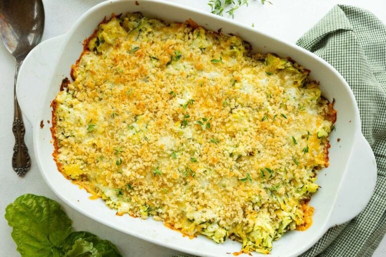 Baked zucchini casserole topped with melted cheese and buttery panko breadcrumbs